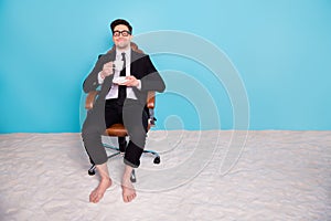 Full length photo of funny dreamy guy dressed black tuxedo enjoying beverage imagining vacation empty space isolated