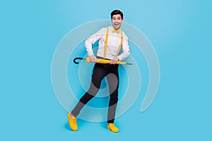 Full length photo of funny excited man hold umbrella enjoy free time discotheque  on blue color background