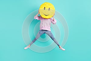 Full length photo of funny funky young woman wear violet sweater jumping cover face smiley isolated turquoise color