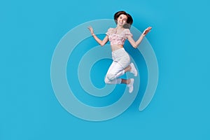 Full length photo of good mood lady dressed trendy clothes rejoice cool purchase jumping empty space isolated on blue