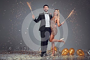 Full length photo of happy happy young loving couple standing isolated over grey background wall. Looking at camera with sparkle