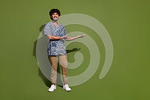 Full length photo hispanic guy trendy outfit holding two arms demonstrate his university presentation isolated on khaki