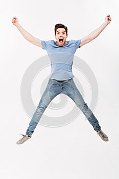 Full-length photo of joyous man 30s in casual t-shirt and jeans