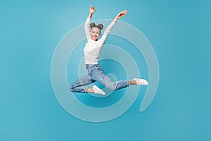 Full length photo of lady jump ballerina pose wear white pullover jeans sneakers isolated blue color background