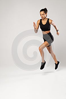 Full length photo of lady jump high up training marathon finish line wear sports suit isolated white background