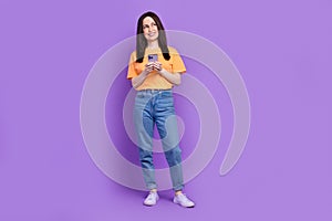 Full length photo of mature woman texting her assistant employee buy coffee look minded empty space isolated on purple