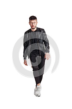 Full-length photo of a funny guy dancing in studio isolated on white background.