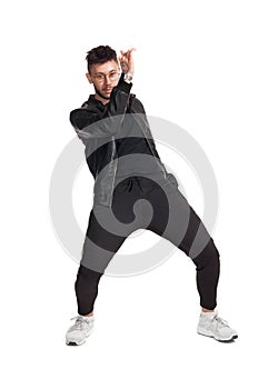 Full-length photo of a funny guy dancing in studio isolated on white background.