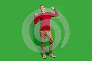Full length photo of perky confident guy wear red sweatshirt brown trousers indicating at himself isolated on green