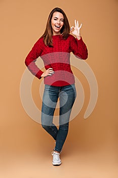 Full length photo of playful brunette woman in casual showing OK