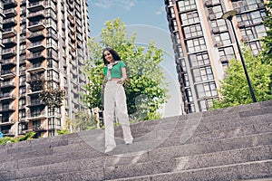 Full length photo of positive good mood glamour lady dressed fashionable outfit walking town street outdoors