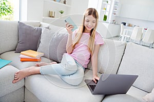 Full length photo of positive little kid girl sit comfy divan homeschool education concept she chatting friends laptop