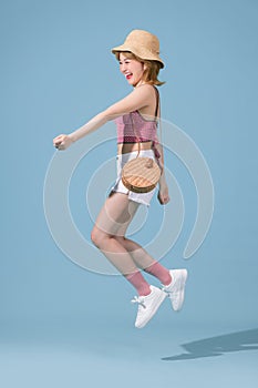 Full length photo of pretty girl enjoying running in summer clothes isolated over blue background