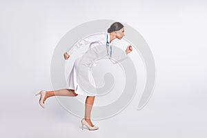 Full length photo of purposeful pretty young lady physician dressed uniform running looking empty space isolated white