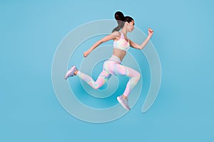 Full length photo of purposeful strong woman dressed sport costume jumping up running fast  blue color