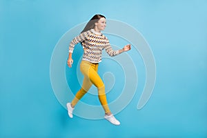 Full length photo of purposeful young woman dressed ornament pullover jumping running isolated blue color background