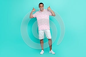 Full length photo of satisfied man wear print t-shirt white shorts two hands showing thumbs up isolated on turquoise