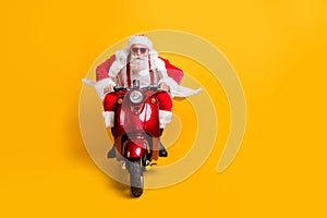 Full length photo of serious santa claus in red hat drive his modern motorbike ride north-pole for christmas x-mas