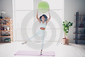 Full length photo of slender adorable woman sportswear rising fitball enjoying cardio training indoors house apartment