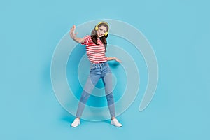 Full length photo of sweet funky lady wear striped t-shirt headphones having fun dancing isolated blue color background