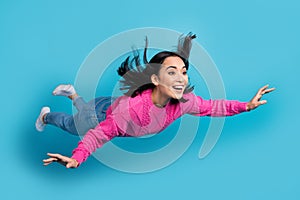 Full length photo of sweet shiny woman dressed pink sweater falling sky smiling isolated blue color background