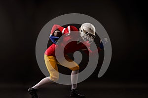 Full-length photo of woman with rugby ball running to right, wearing helmet