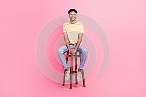 Full length photo of young applicant man wear t-shirt denim jeans sitting bartender chair waiting his turn  on