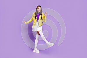 Full length photo of young cheerful girl have fun dancer party modern outfit platform isolated over purple color