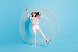 Full length photo of young excited woman crazy have fun enjoy discotheque hold boombox isolated over blue color