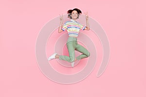 Full length photo of young girl happy positive smile show peace cool v-sign isolated over pink color background