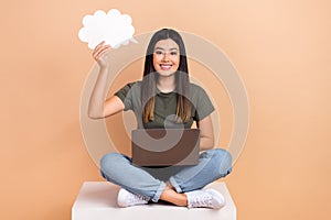 Full length photo of young woman sit box smart hold speech bubble cloud idea brainstorming use netbook isolated on beige