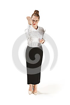 Full length portrait of angry female teacher holding a folder isolated against white background