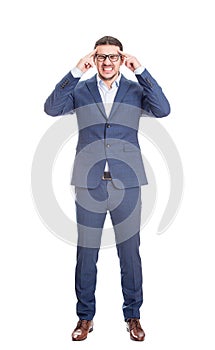 Full length portrait of anxious businessman keeps hands to temples focusing his mind, hard thinking isolated on white background.