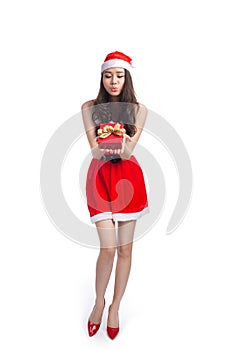 Full length portrait of a asian woman in santa claus cloth holding gift box isolated on a white background