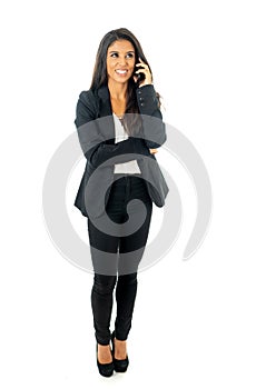 Full length portrait of Attractive latin corporate latin woman looking confident making a call on her mobile phone in Creative