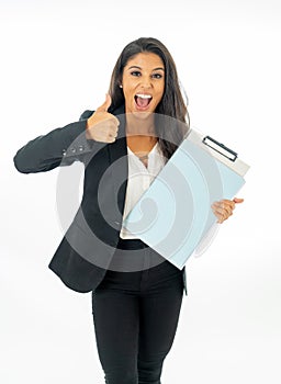 Full length portrait of Attractive latin corporate latin woman looking excited and holding folder and paperwork in Creative