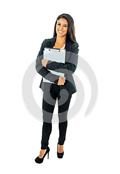 Full length portrait of Attractive latin corporate latin woman looking excited and holding folder and paperwork in Creative