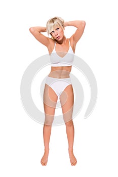 Full length portrait of a beautiful blonde woman wearing a white bikini