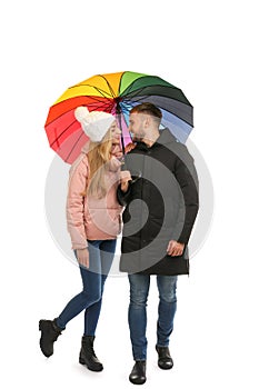 Full length portrait of beautiful couple with umbrella