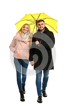 Full length portrait of beautiful couple with umbrella