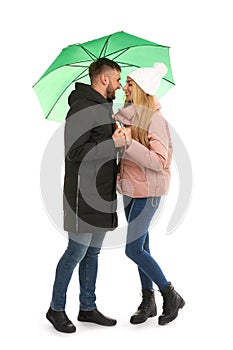 Full length portrait of beautiful couple with umbrella