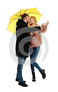 Full length portrait of beautiful couple with umbrella