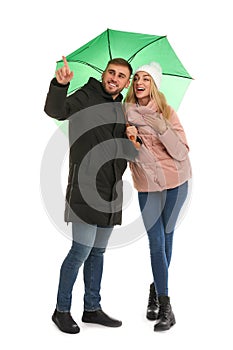 Full length portrait of beautiful couple with umbrella