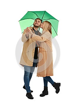 Full length portrait of beautiful couple with umbrella