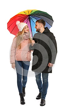 Full length portrait of beautiful couple with umbrella