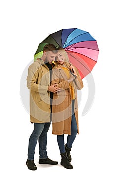 Full length portrait of beautiful couple with umbrella