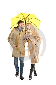 Full length portrait of beautiful couple with umbrella