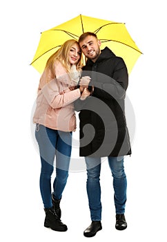 Full length portrait of beautiful couple with umbrella