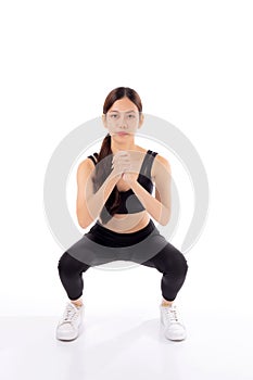 Full length portrait beautiful young asian woman in sportswear practicing doing squats for bodybuilder isolated.