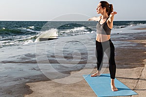 Full-length portrait of beautiful young sport woman doing yoga e
